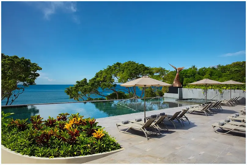 Elegant resort suite with a king bed and balcony.