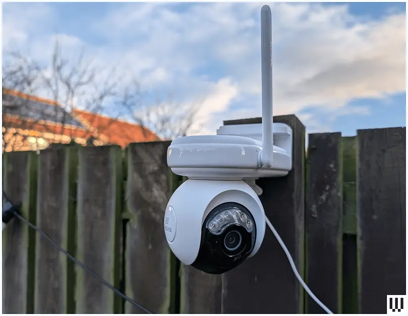 Compact security camera with night vision pointed at a yard.